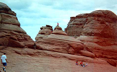 Kids perched on rock tower